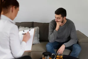 A thinking man and a woman sitting together in a consultation room